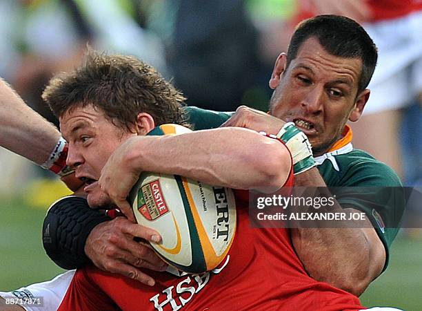 Danie Rossouw of The Springboks tackles Jamie Heaslip of The British and Irish Lions during the second Rugby Test in Pretoria at Loftus Versfeld...