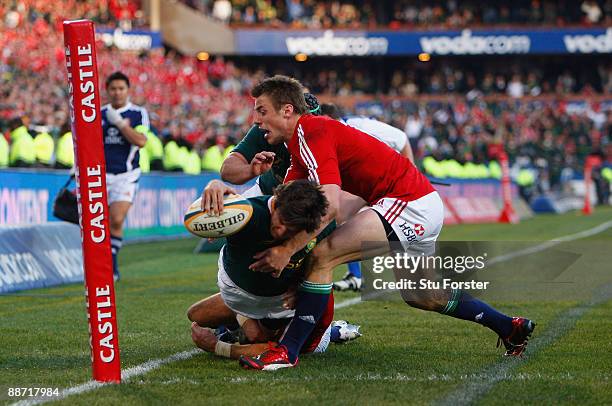 Sprinboks replacement Jaque Fourie dives over to score a try despite the tackle of Tommy Bowe during the Second Test match between the South Africa...