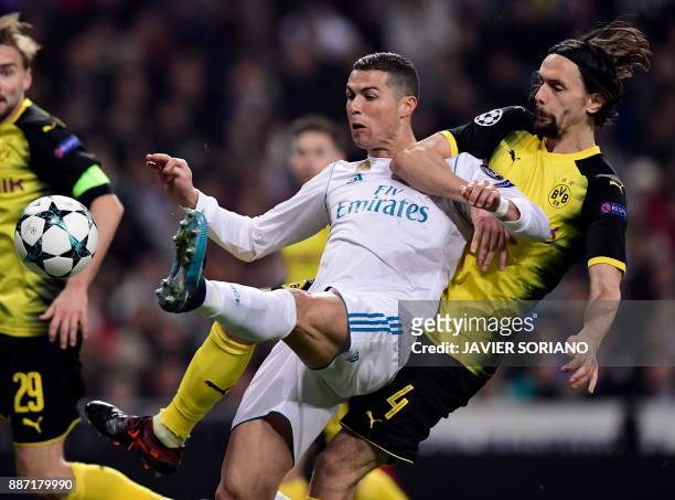 Dortmund's Serbian defender Neven Subotic vies with Real Madrid's Portuguese forward Cristiano Ronaldo during the UEFA Champions League group H...
