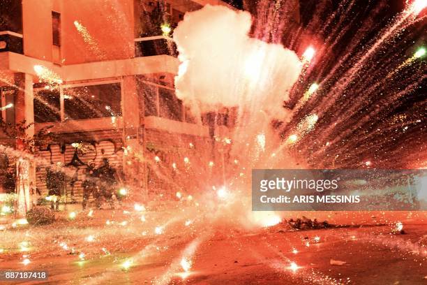 Firework explodes at riot police during clashes with protesters in central Athens on December 6 after a demonstration commemorating 15-year-old...
