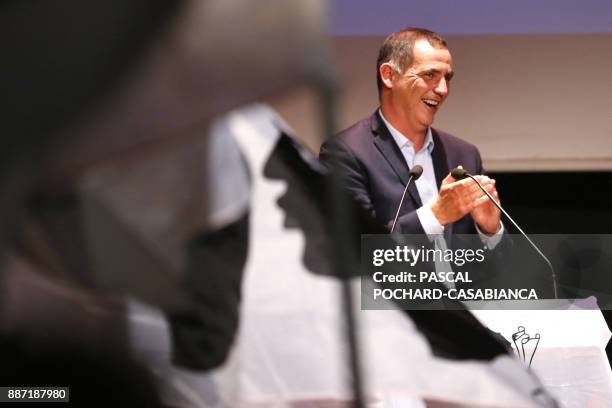 People wave Corsican flags as candidate for the Pe a Corsica nationalist party for Corsican regional elections Gilles Simeoni delivers a speech...