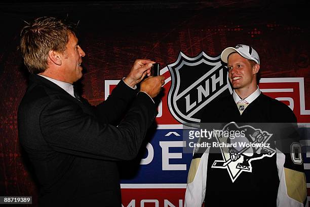 Philip Samuelsson of the Pittsburgh Penguins poses for his father Ulf Samuelsson after being pick in second round of the 2009 NHL Entry Draft at the...