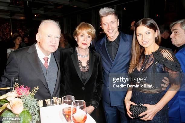 Gerhard Rueschenbeck and his wife pictured with Robert Lewandowski and his wife Anna Lewandowska attend the Rueschenbeck and BUNTE reception at Hotel...