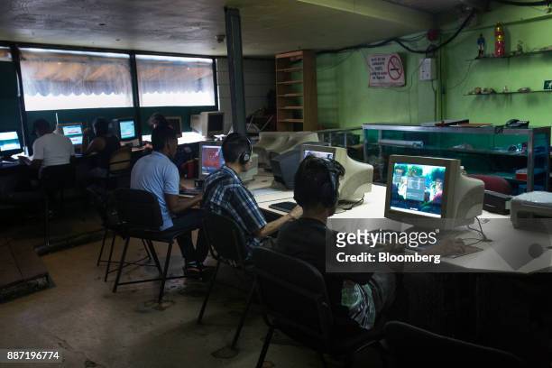 People play video games on computers at a cybercafe in Caracas, Venezuela, on Tuesday, Nov. 28, 2017. Crisis-wracked Venezuela has become fertile...