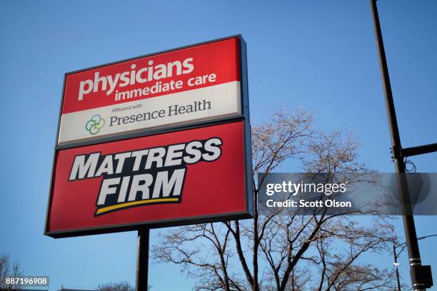 Sign hangs outside a Mattress Firm store on December 6, 2017 in Chicago, Illinois. Steinhoff International Holdings N.V., which is the parent company...