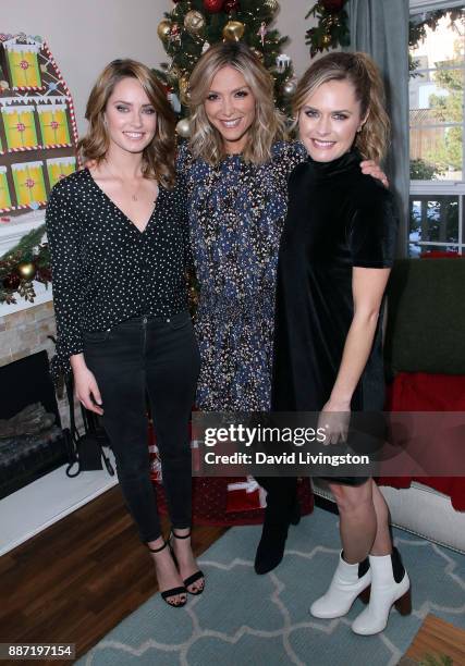 Actresses Merritt Patterson and Maggie Lawson pose with host Debbie Matenopoulos at Hallmark's "Home & Family" at Universal Studios Hollywood on...