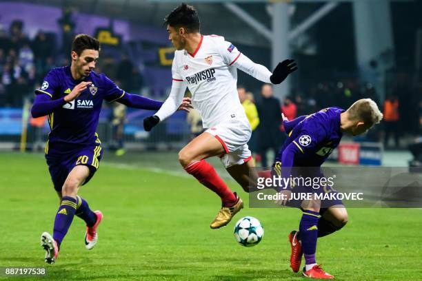 Sevilla's Argentinian midfielder Joaquin Correa vies with Maribor's Slovenian forward Gregor Bajde and Slovenian defender Martin Milec during the...
