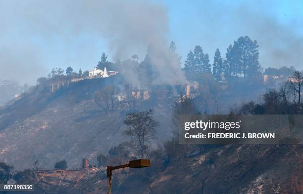 The remains of homes burned on a hilltop are seen in Bel Air, east of the 405 freeway on December 6, 2017 in Los Angeles, California. California...