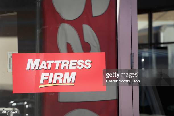 Sign hangs in the window of a Mattress Firm store on December 6, 2017 in Chicago, Illinois. Steinhoff International Holdings N.V., which is the...