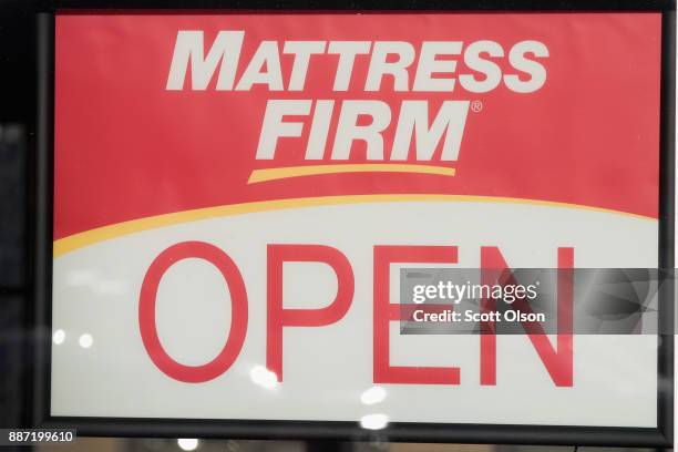 Sign hangs in the window of a Mattress Firm store on December 6, 2017 in Chicago, Illinois. Steinhoff International Holdings N.V., which is the...