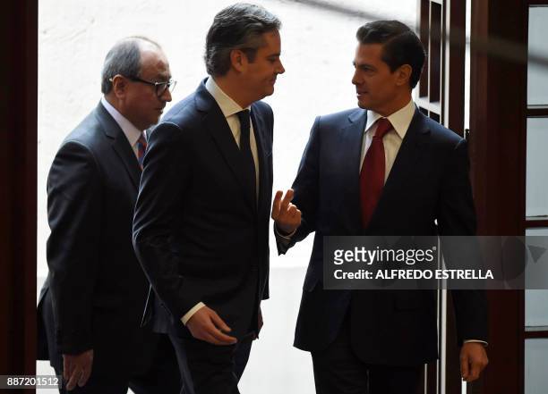 Mexican President Enrique Pena Nieto speaks with outgoing Education Minister, Aurelio Nuno, during a ceremony at Los Pinos Presidential Residence in...