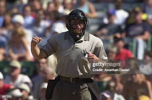 Umpire Chris Guccione calls an out during the game between the Cincinnati Reds and the Chicago Cubs on June 26, 2002 at Wrigley Field in Chicago,...