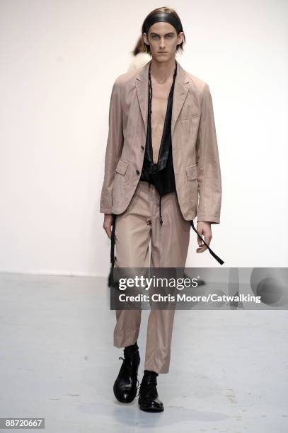 Model walks the runway during the Ann Demeulemeester fashion show at Paris Fashion Week Menswear Spring/Summer 2010 at Musee de l'Homme on June 27,...