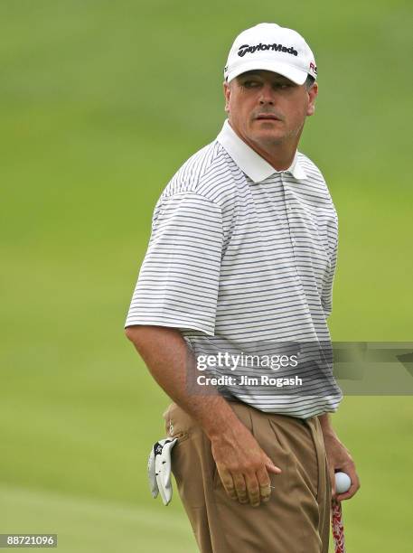 Paul Goydos looks over his shoulder on the 18th green during round three of the 2009 Travelers Championship at TPC River Highlands on June 27, 2009...