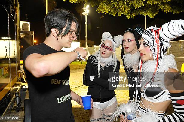 Musician Jeremy Dawson of Shiny Toy Guns talks with some exotic stage dancers backstage at the 13th annual Electric Daisy Carnival electronic music...