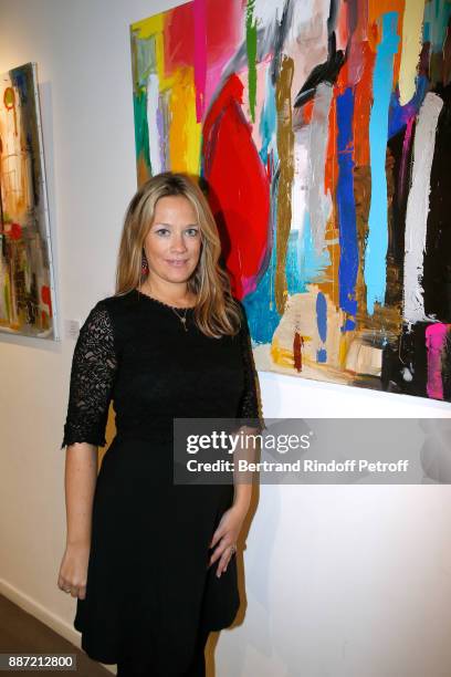 Painter Caroline Faindt poses in front of her works during her Exhibition Opening. Caroline has found the key to fulfillment by creating works of...