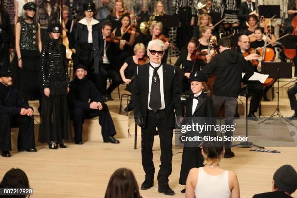 Fashion designer Karl Lagerfeld and Hudson Kroenig during the Chanel "Trombinoscope" collection Metiers d'Art 2017/18 show at Elbphilharmonie on...