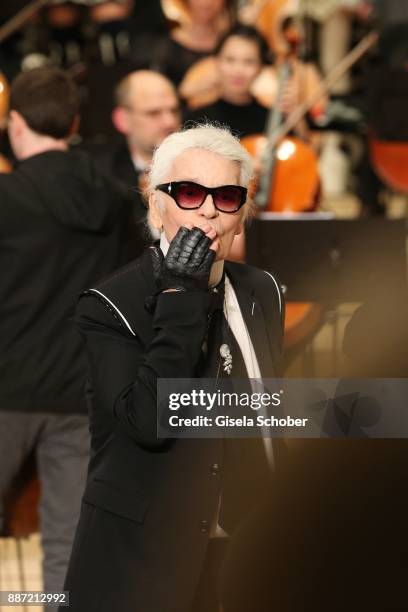 Fashion designer Karl Lagerfeld and Hudson Kroenig during the Chanel "Trombinoscope" collection Metiers d'Art 2017/18 show at Elbphilharmonie on...