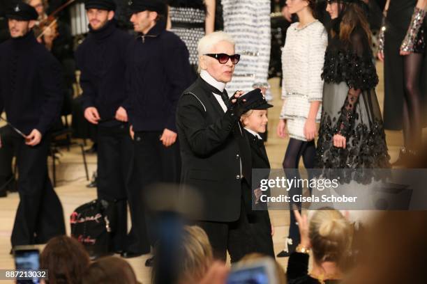 Fashion designer Karl Lagerfeld and Hudson Kroenig during the Chanel "Trombinoscope" collection Metiers d'Art 2017/18 show at Elbphilharmonie on...