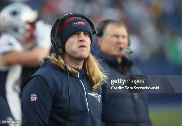 Safeties coach Steve Belichick of the New England Patriots and his father head coach Bill Belichick look on from the sidelines during NFL game action...