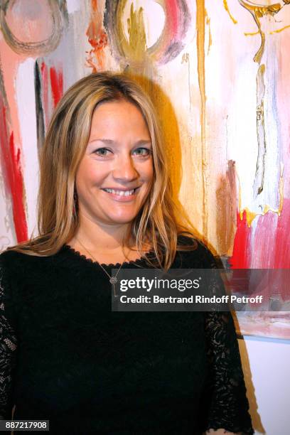 Painter Caroline Faindt poses in front of her works during her Exhibition Opening. Caroline has found the key to fulfillment by creating works of...