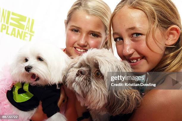 Actress Noah Cyrus and friend arrive with their dogs for the grand opening party for the Artist Knox Luxury Grooming Pet Salon on June 27, 2009 in...