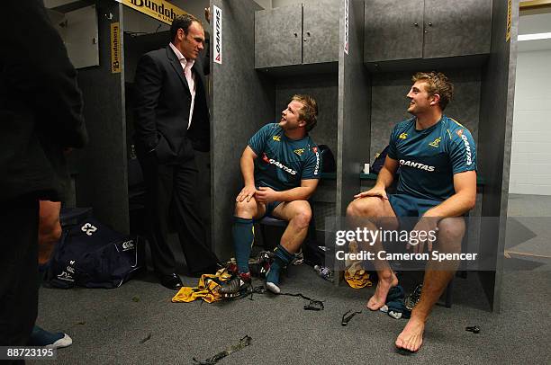 Former Wallaby Nathan Gray talks to Benn Robinson and Dean Mumm of the Wallabies in the change room after winning the Test match between the...