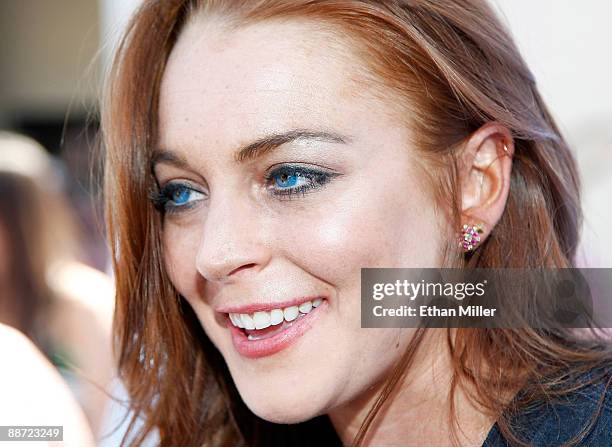 Actress Lindsay Lohan is interviewed as she arrives at the Wet Republic pool at the MGM Grand Hotel/Casino to celebrate her birthday and her Sevin...