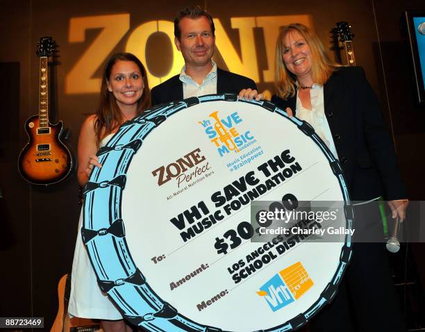 Save The Music's Jenn Revoir and LA Unified School District Representative Steven Venz receive a check for VH1's Save The Music Foundation on behalf...