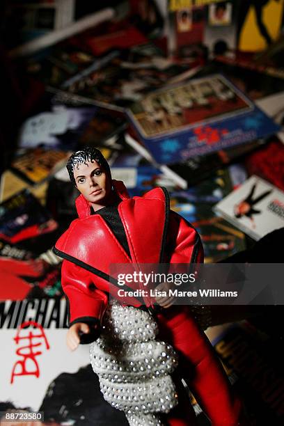 Australian Michael Jackson tribute artist Jason Jackson holds a Jackson doll amongst his memarobilia collection at his Sydney home on June 28, 2009...