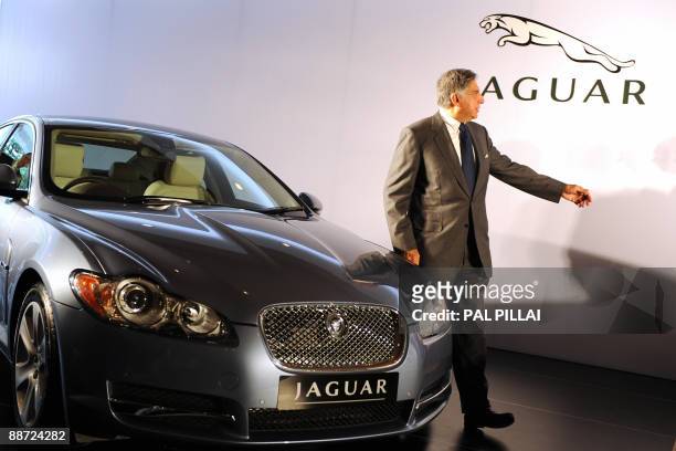 Tata Group and Tata Motors Chairman Ratan Tata poses with a Jaguar XF during a press conference to announce Jaguar Land Rover's Indian market debut...
