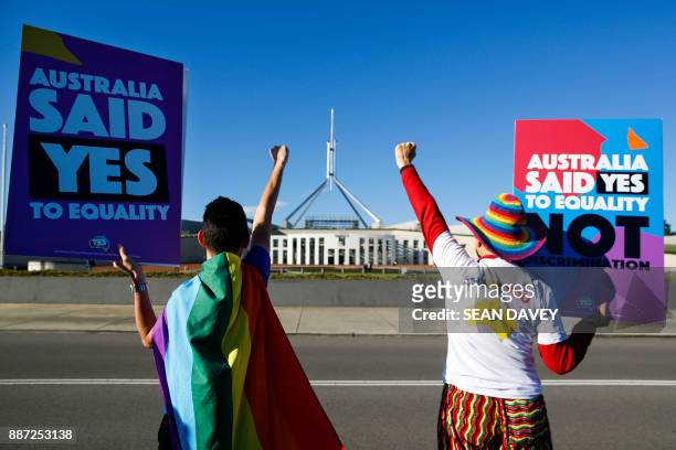 Equality ambassadors and volunteers from the Equality Campaign celebrate as they gather in front of Parliament House in Canberra on December 7 ahead...
