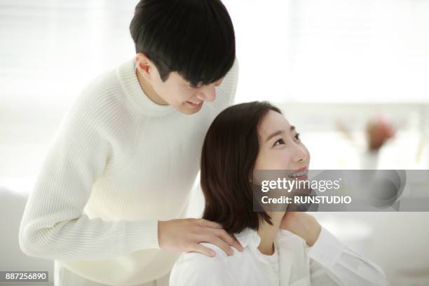 man giving massage woman's shoulder - girlfriend massage ストックフォトと画像