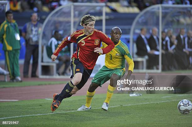 Spanish forward Fernando Torres and South African defender Tsepo Masilela fight for the ball during the Fifa Confederations Cup third place play-off...
