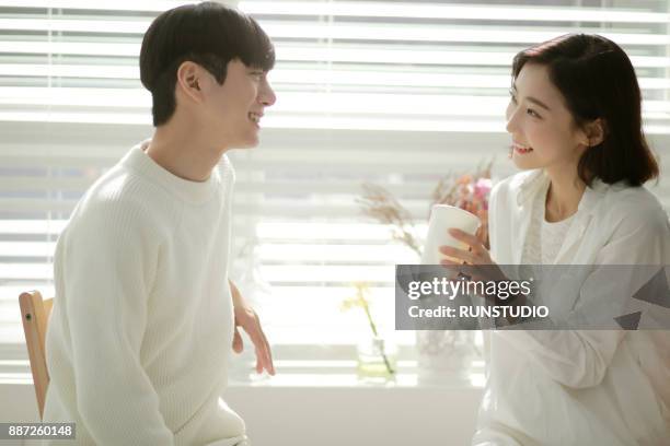 couple relaxing and drinking coffee - korean man stock pictures, royalty-free photos & images