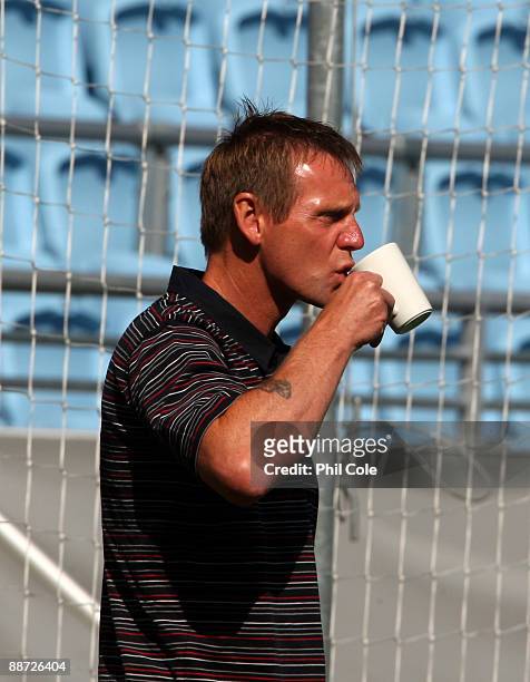 Stuart Pearce, manager of England U21, drinks during an walk about in the New Stadium instead of training ahead of their UEFA European Under-21...