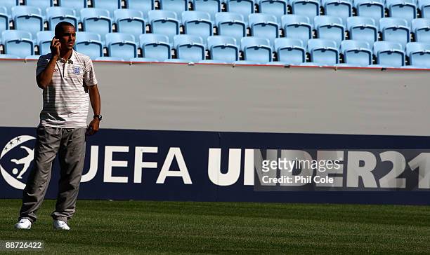 Theo Walcott of England talks on a mobile phone during an walk about in the New Stadium instead of training ahead of their UEFA European Under-21...