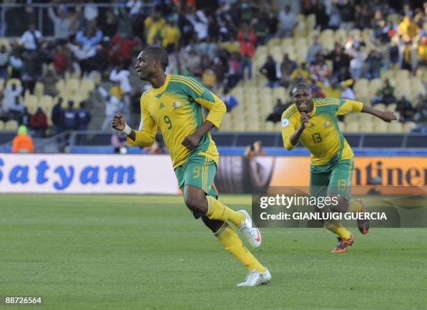 South African forward Katlego Mphela celebrates with South African midfielder Kagisho Dikgacoi after scoring the second goal during the Fifa...