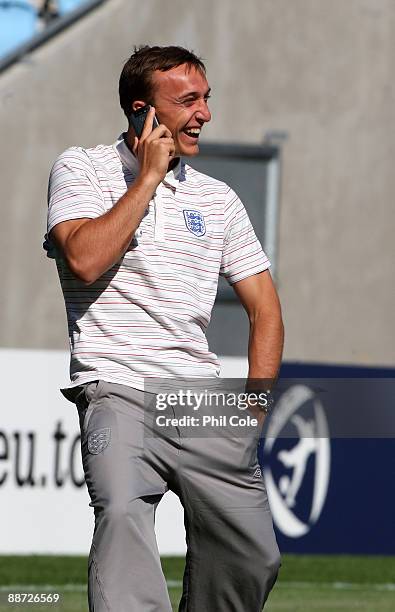 Mark Noble of England talks on a mobile phone during a walk about in the New Stadium instead of training ahead of their UEFA European Under-21...