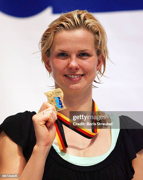 Britta Steffen of SG Neukoelln Berlin presents her medal for the german title after winning the women's 50 m freestyle A final during the German...