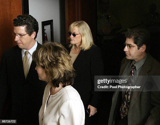 Debbie Rowe , Michael Jackson's ex-wife and mother of two of his children, is surrounded by people as she leaves the courtroom after court adjourns...