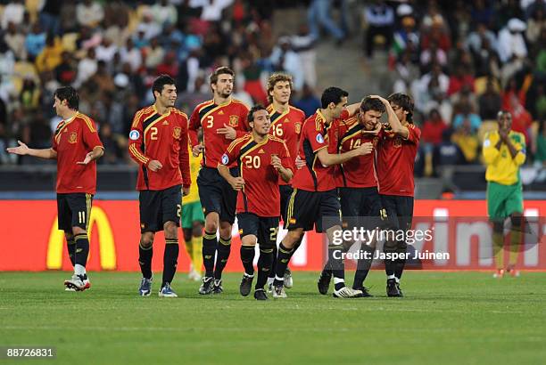 Xabi Alonso of Spain is congratulated by team mates after scoring in extra time during the FIFA Confederations Cup 3rd Place Playoff between Spain...