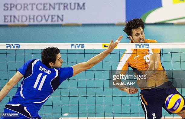 Italian Cristian Savani attempts to catch the ball from Dutch Jeroen Trommel during the World League volleyball match in Eindhoven, on June 282009...