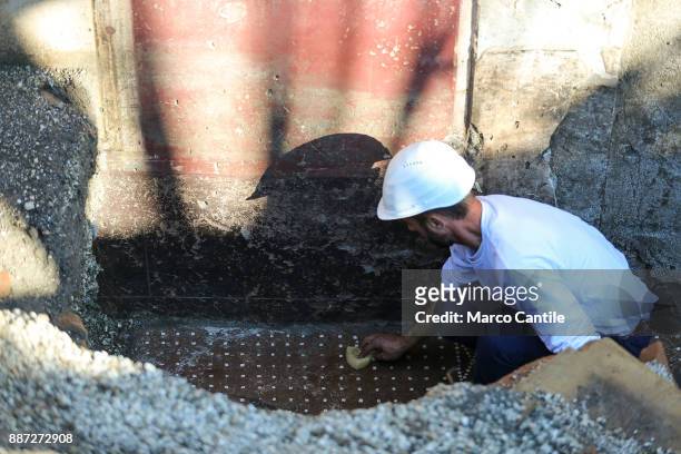 Restorer at work on a mosaic in the Schola Armaturarum, the first excavation of Pompeii in an area that has never been investigated, after more than...