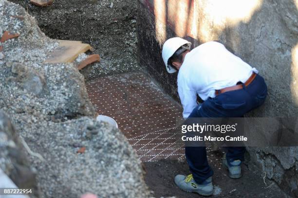Restorer at work on a mosaic in the Schola Armaturarum, the first excavation of Pompeii in an area that has never been investigated, after more than...