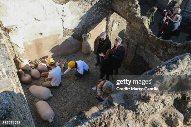 Restorers at work on amphorae in the Schola Armaturarum, the first excavation of Pompeii in an area that has never been investigated, after more than...