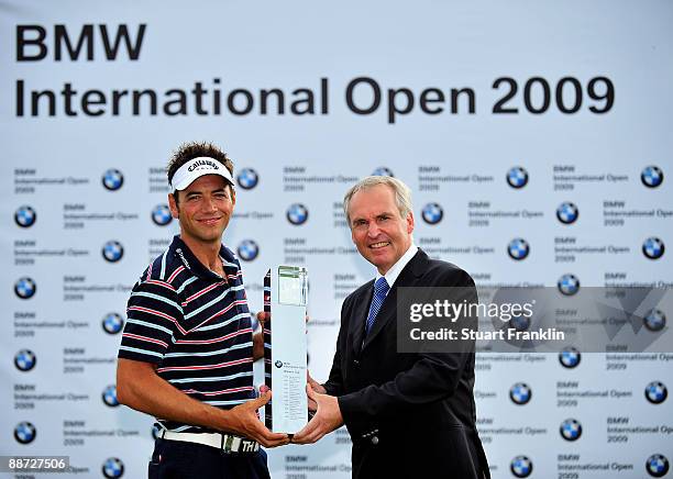 Nick Dougherty of England is presented with the winners trophy by Doctor Friedrich Eichiner, Member of the board of the BMW group after the final...
