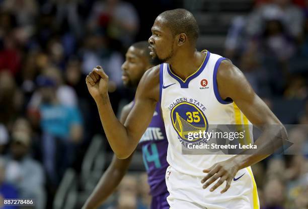 Kevin Durant of the Golden State Warriors reacts after a play against the Charlotte Hornets during their game at Spectrum Center on December 6, 2017...