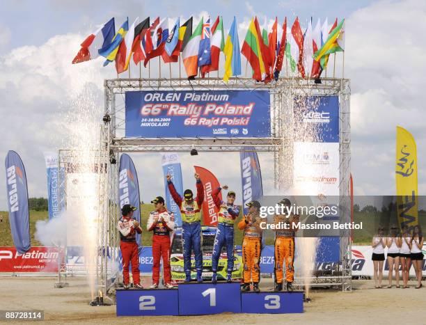 Mikko Hirvonen and Jarmo Lehtinen of Finland celebrate their victory on the podium after the WRC Rally of Poland on June 28, 2009 in Mikolajki,...