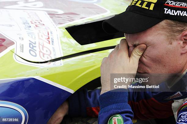 Jari Matti Latvala of Finland looks despondent as he inspects the damage to his BP Abu Dhabi Ford Focus after crashing during the last stage of third...